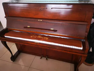 An antique Hoffmann Piano with a stool in exceptional condition
