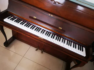 An antique Hoffmann Piano with a stool in exceptional condition