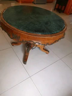 An ornate antique dinning/entrance table. In rare green marble top.