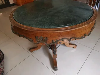 An ornate antique dinning/entrance table. In rare green marble top.