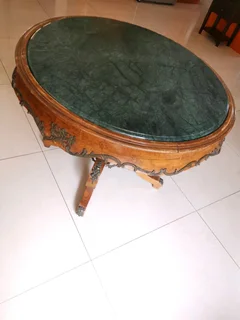 An ornate antique dinning/entrance table. In rare green marble top.