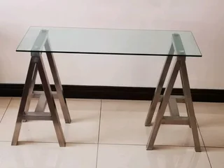 Glass table on heavy metal trusses, made with quality material. Dimensions are W126/H77/D60