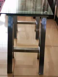Glass table on heavy metal trusses, made with quality material. Dimensions are W126/H77/D60