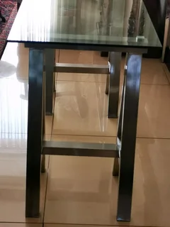 Glass table on heavy metal trusses, made with quality material. Dimensions are W126/H77/D60