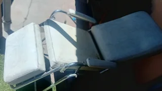 Reclining studio chair  chrome and leather(?)in fair condition ,with fully manual reclining action