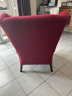 Red velvet wing back chair