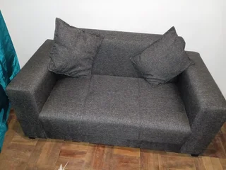2 seater with scattered cushions for R2000