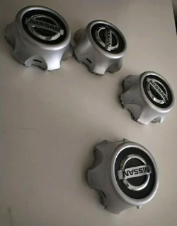 NISSAN Wheel Center Caps A Set Of Four On Sale.