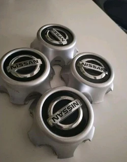 NISSAN Wheel Center Caps A Set Of Four On Sale.