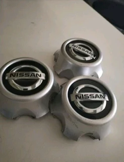 NISSAN Wheel Center Caps A Set Of Four On Sale.
