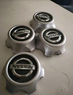 NISSAN Wheel Center Caps A Set Of Four On Sale.