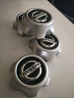 NISSAN Wheel Center Caps A Set Of Four On Sale.