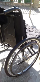 Wheelchair affordable,foldable,steel frame heavy duty with detachable foot rest pedals.
