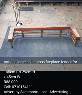 Antique large solid brass fireplace fender for sale.