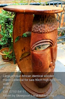Large antique African identical wooden mask cocktail pedestal for sale