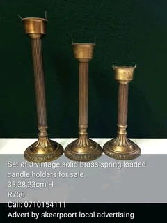 Set of 4 large vintage solid brass candle holders for sale.