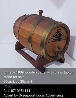 Vintage 1909 wooden barrel with brass tap and strapping on stand for sale