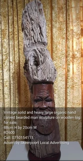 Vintage solid and large organic hand carved bearded man sculpture on wooden log for sale