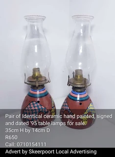 Pair of Identical ceramic hand painted signed and dated lamps for sale.