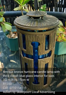 Antique bronze hurricane candle lamp with cobalt blue glass interior for sale