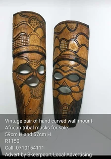 Vintage pair of hand carved wall mount African tribal mask for sale