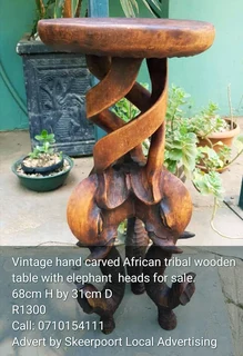 Vintage hand carved African tribal wooden table with elephant heads for sale