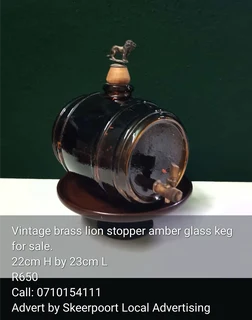 Vintage brass lion stopper amber glass keg for sale.