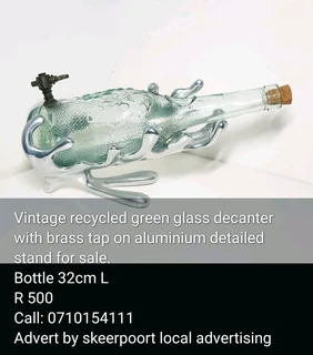Vintage recycled green glass decanter with brass tap on aluminium detailed stand for sale.