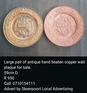 Large pair of antique hand beaten copper wall plaque for sale.