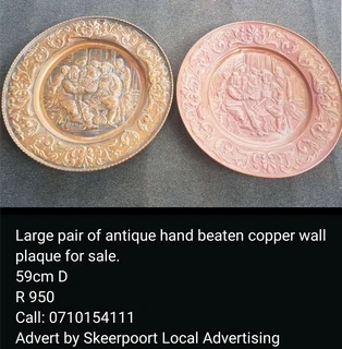 Large pair of antique hand beaten copper wall plaque for sale.