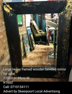 Large black framed mirror for sale.