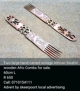 Two large hand carved vintage African swahili wooden afro combs for sale.