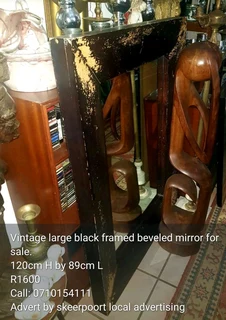 Vintage large black framed beveled mirror for sale.