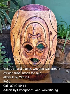 Vintage hand carved wooden wall mount Aftican tribal mask for sale.