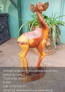 Vintage large solid wood brass eared deer statue for sale.