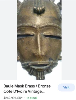 Vintage brass and bronze framed Baule mask for sale.