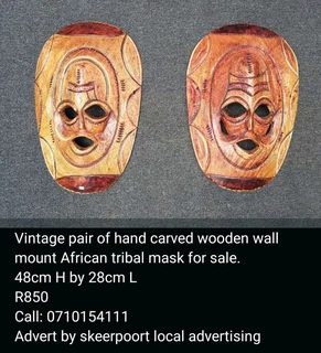 Vintage pair of carved wooden wall mount mask for sale.
