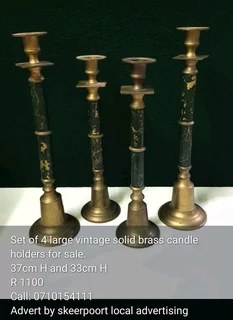 Set of 4 large vintage solid brass candle holders for sale.