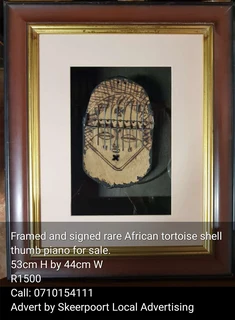 Rare framed and signed Sancho African tortoise shell thumb piano for sale.
