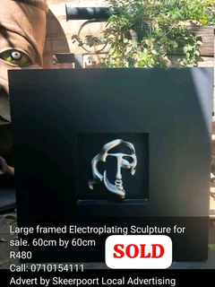 Large framed electroplated face sculpture for sale