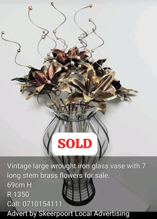 Vintage large wrought iron glass vase with 7x long stem brass flowers for sale.