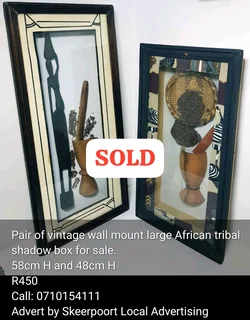 Vintage pair of wall mount African tribal shaodw box for sale.
