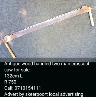 Antique wood handled two man crosscut saw for sale.