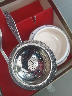 boxed set of a tea strainer with a porcelain bowl and a matching spoon &#34;Novalux Plate&#34;
