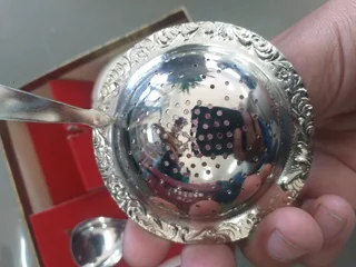 boxed set of a tea strainer with a porcelain bowl and a matching spoon &#34;Novalux Plate&#34;