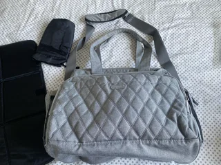 Woolworths nappy bag, thermal compartments and bottle holder, a mat