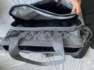 Woolworths nappy bag, thermal compartments and bottle holder, a mat