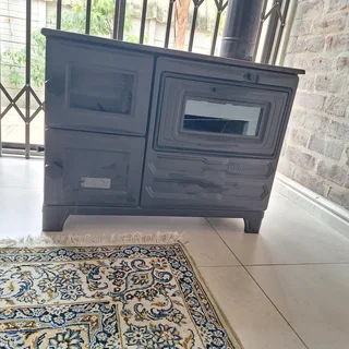 Wood burning Cast iron fireplace/heater with oven.