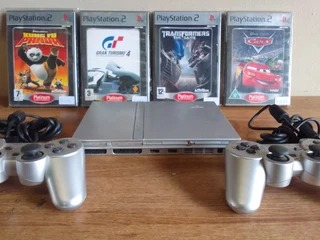 Ps2 plus 2 remotes and 4 games