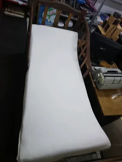 Old antique toddler bed with mattress